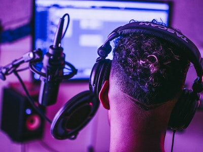 A guy wearing headphone in sound room