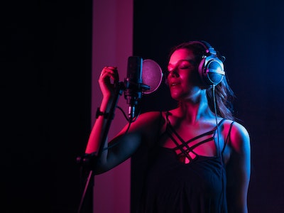 A girl singer wearing headphones